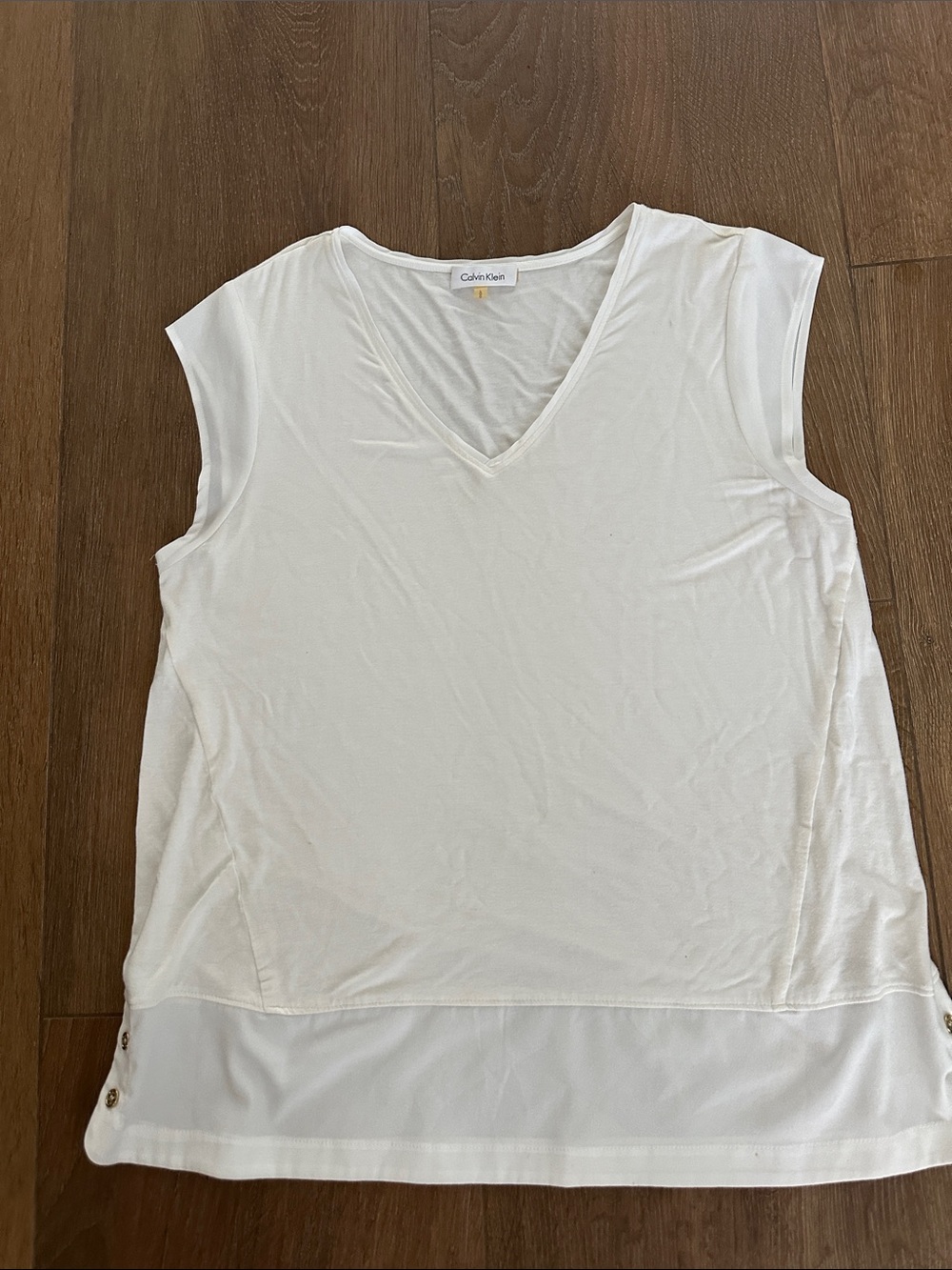 Calvin Klein women's Ivory V-Neck Sleeveless Blouse with Sheer Hem. Sizes L.